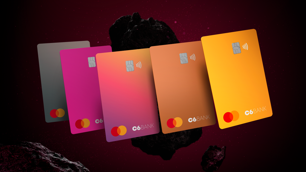 Imagem virtual do cartões do C6 Bank com as cinco novas cores lado a lado em primeiro plano afrente de uma rocha espacial ao fundo