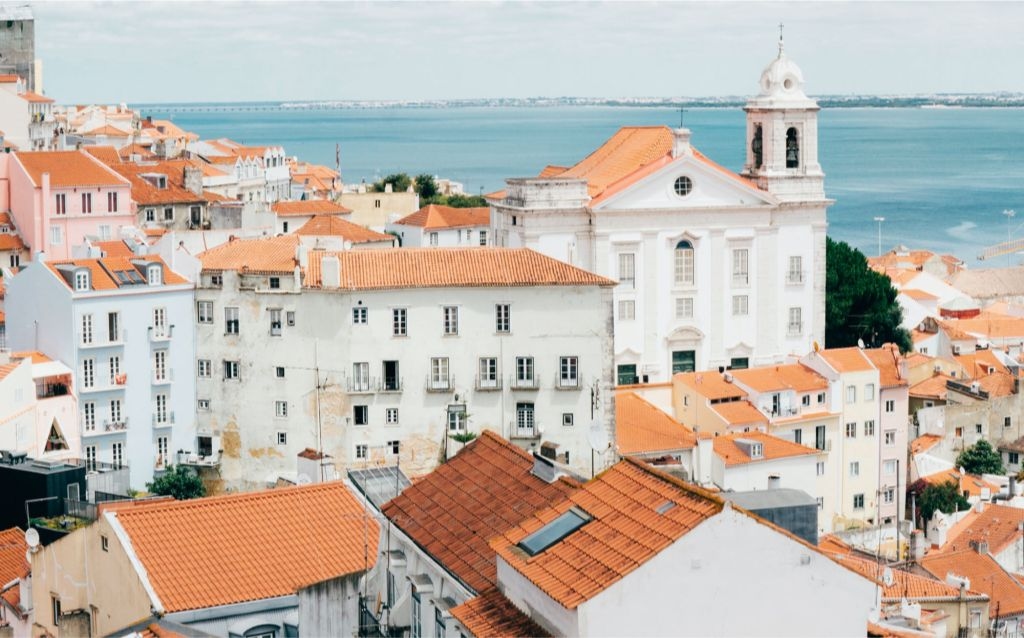 viagem de carro - casas e arquitetura portuguesas bairro português com telhados vermelhos e casas e prédios brancos
